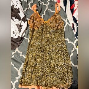 Leopard print babydoll dress with orange lace trim and adjustable straps